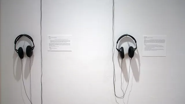Headphones haning on a wall in the installation.